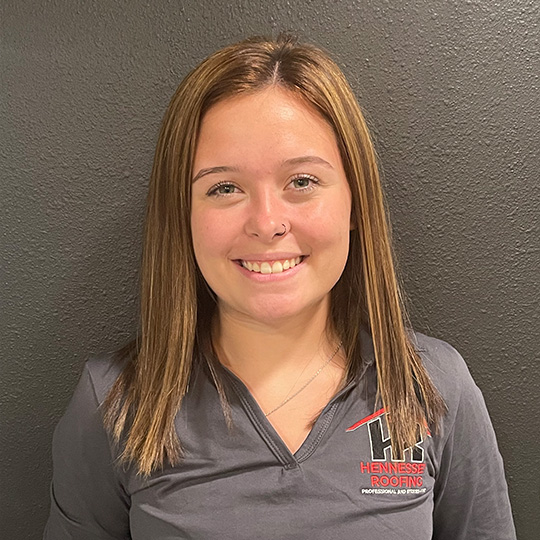 Makayla Kamlan Professional Headshot for Hennessey Roofing in Colorado Springs and Navarre Florida in a Hennessey Roofing Shirt